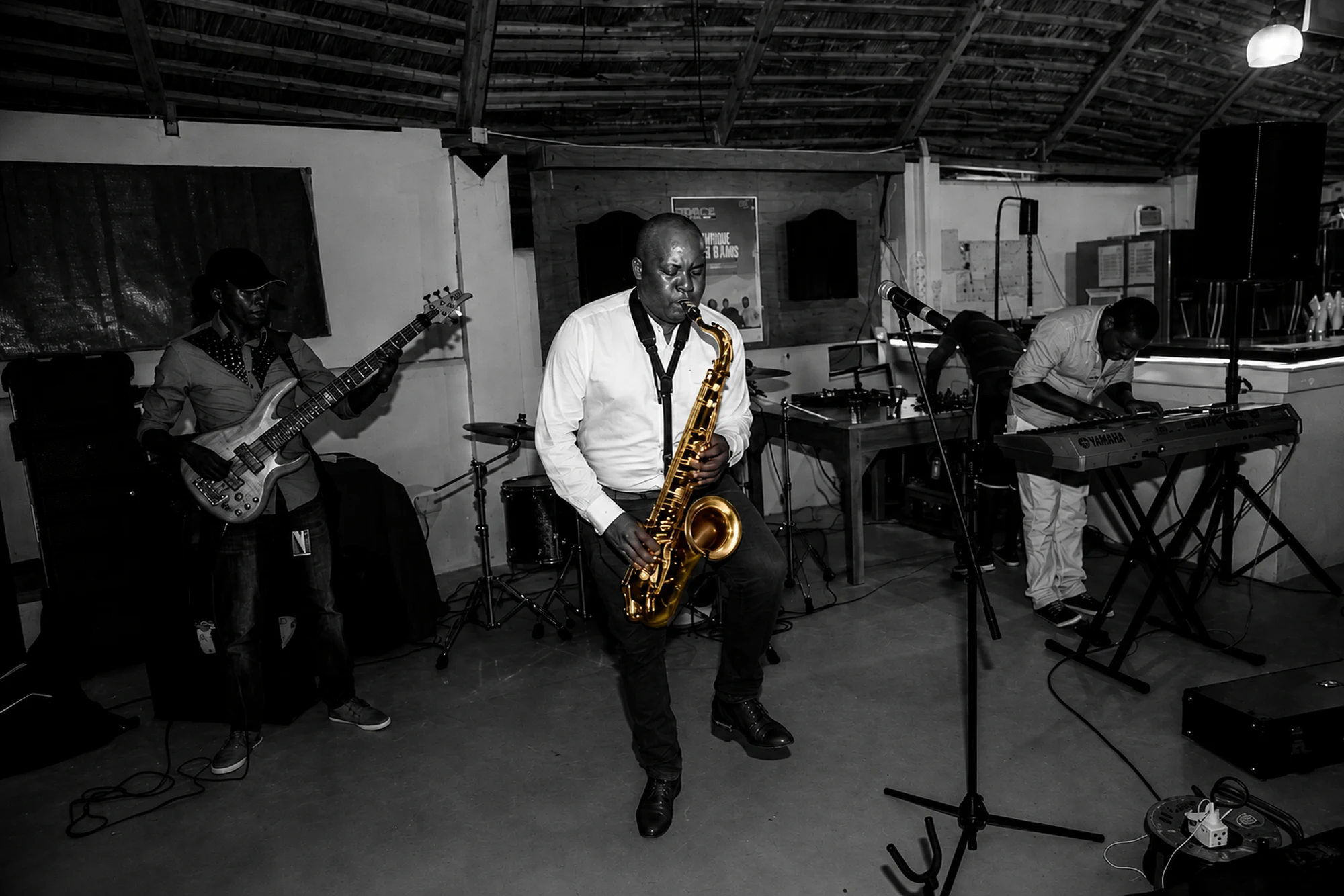 Different Faces Band performing, bass and keys either side of the horn