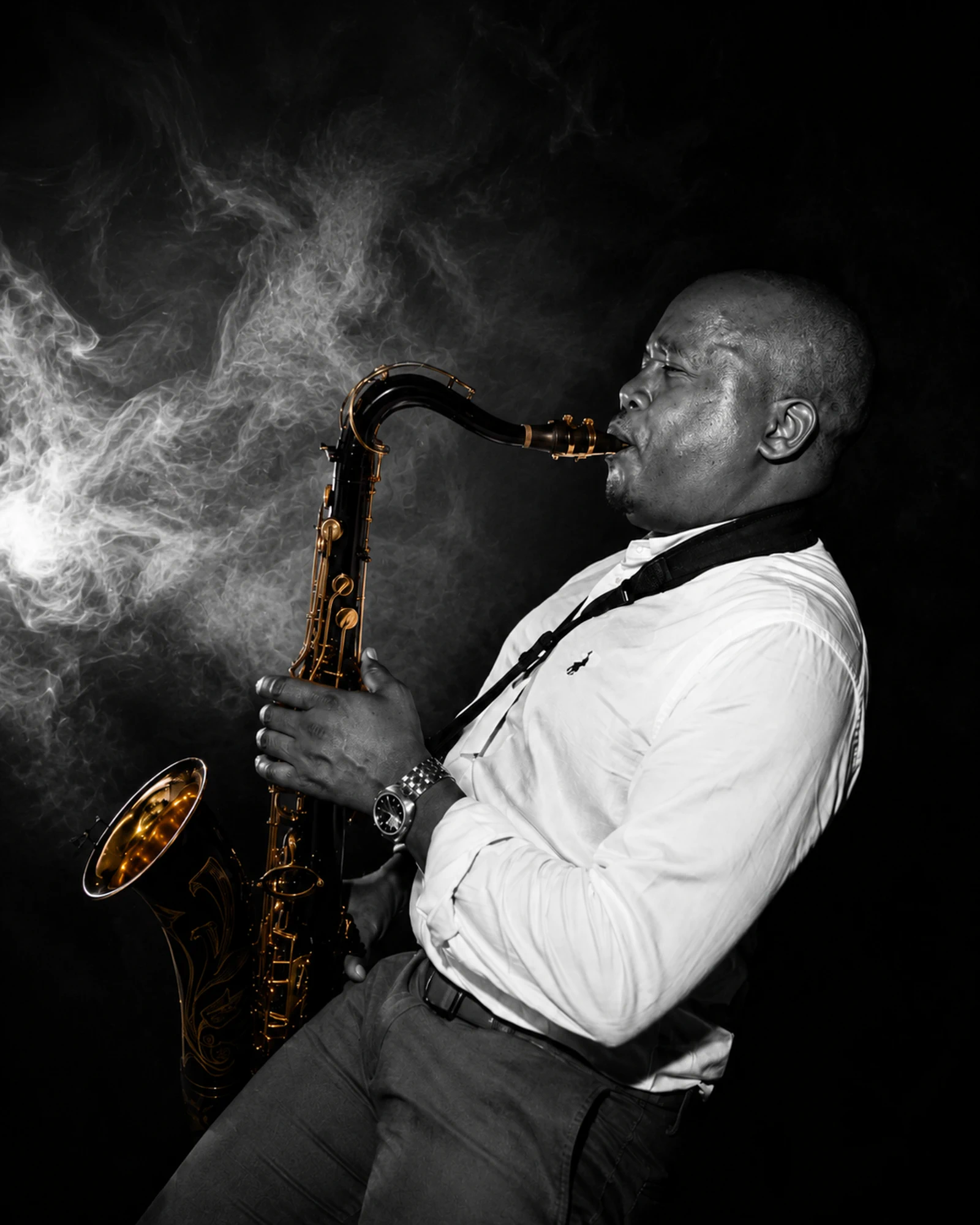Edward Parseen in a white shirt, saxophone raised, smoke behind him
